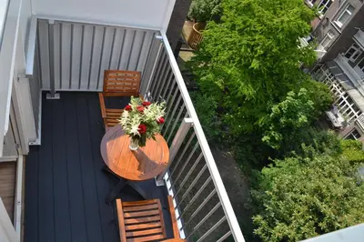 an overhead view of a table and chairs on a balcony at Alp Hotel in Amsterdam
