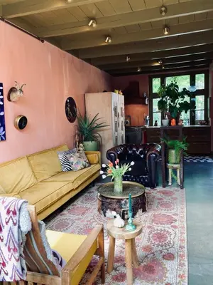 a living room with a couch and a table at Cosy real Dutch family house anno 1910 in Alkmaar