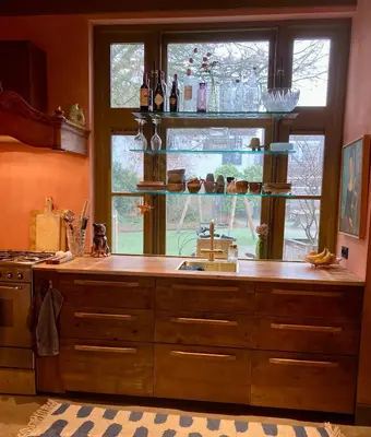 a kitchen with a sink and a large window at Cosy real Dutch family house anno 1910 in Alkmaar