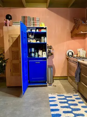 a blue door in the middle of a kitchen at Cosy real Dutch family house anno 1910 in Alkmaar