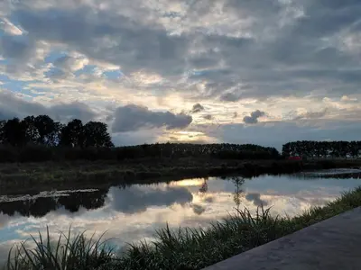 a view of a lake with a cloudy sky at Villa Suite Oudshoorn in Alphen aan den Rijn