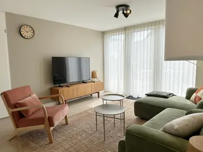 a living room with a couch and a tv at Vakantiehuis voor mindervaliden op Recreatiepark De Wielen - 61 in Sint Maarten