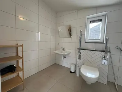 a bathroom with a toilet and a sink at Vakantiehuis voor mindervaliden op Recreatiepark De Wielen - 61 in Sint Maarten