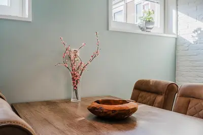 a table with a vase of flowers on a table at Vacation home Oase in Egmond aan Zee