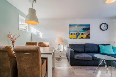a living room with a couch and a table at Vacation home Oase in Egmond aan Zee