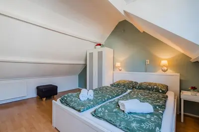 a bedroom with a bed with two towels on it at Vacation home Oase in Egmond aan Zee