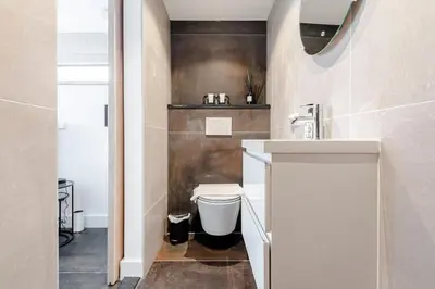 a bathroom with a toilet and a sink at Fazantisch Studio for 2 with private parking in Zandvoort
