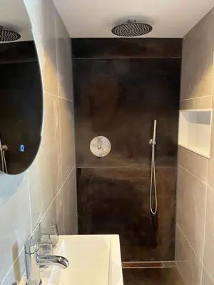 a bathroom with a shower and a white sink at Fazantisch Studio for 2 with private parking in Zandvoort