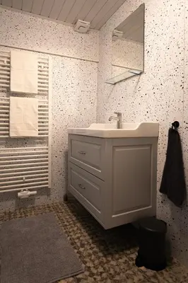 a white bathroom with a sink and a mirror at Boerenvakantie in Hilversum