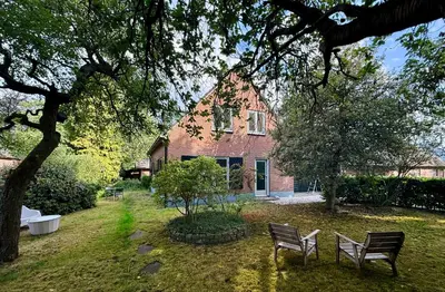 two benches in front of a brick house at Boerenvakantie in Hilversum