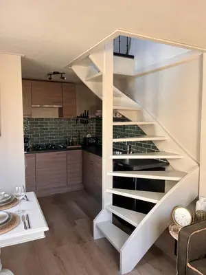 a staircase in a kitchen with a wine cellar at Beachhouse Noteboom, omheinde tuin in Noordwijk aan Zee