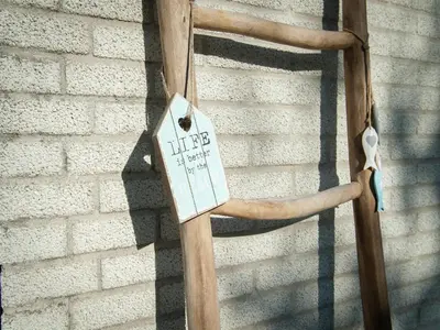 a wooden pole with a sign on a wall at Bungalow in South Holland near the Beach in Noordwijk