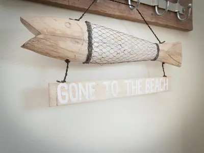 a sign that says gone to the beach with a net at Bungalow in South Holland near the Beach in Noordwijk