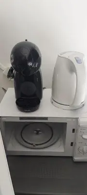 a coffee maker and a toaster sitting on top of a microwave at Walhalla in Zandvoort