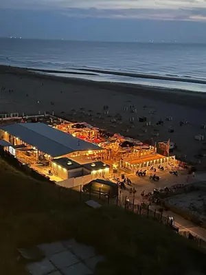a building on the beach at night at Walhalla in Zandvoort