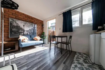 a living room with a couch and a table at Tiny House Zaandam, Tranquility and easy Connection in Zaandam