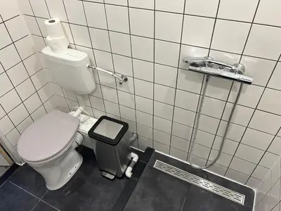 a bathroom with a toilet and a trash can at Tiny House Zaandam, Tranquility and easy Connection in Zaandam