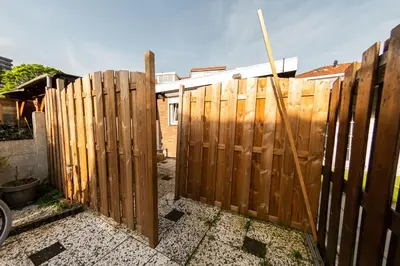 a wooden fence in front of a house at Tiny House Zaandam, Tranquility and easy Connection in Zaandam