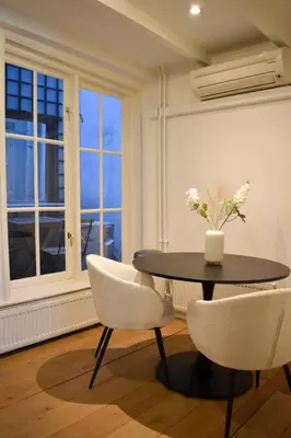 a dining room with a table and two chairs at NEW cosy apartment in 9 streets in Amsterdam