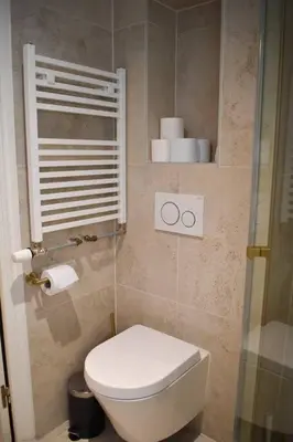 a small bathroom with a toilet and some towels at NEW cosy apartment in 9 streets in Amsterdam