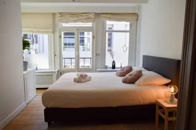 a bedroom with a bed with two teddy bears on it at NEW cosy apartment in 9 streets in Amsterdam