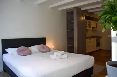 a bedroom with a large white bed with two towels at NEW cosy apartment in 9 streets in Amsterdam