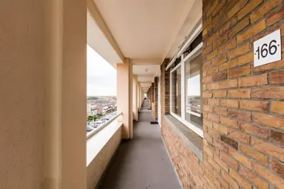 an empty hallway of a building with a brick wall at Strand166 in Egmond aan Zee