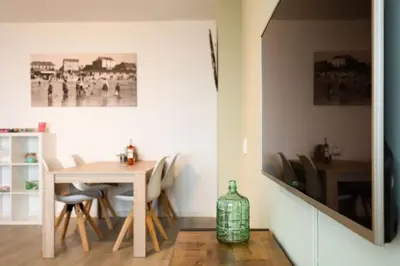 a dining room with a table and chairs at Strand166 in Egmond aan Zee