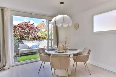 a dining room with a table and chairs and a window at City apartment Alkmaar in Alkmaar