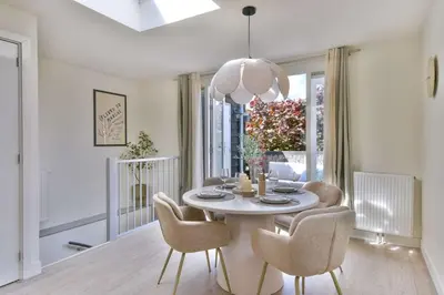 a dining room with a white table and chairs at City apartment Alkmaar in Alkmaar