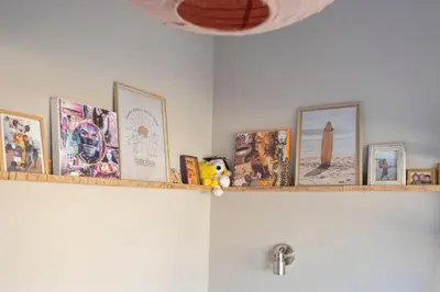 a shelf with a bunch of pictures on it at Beachhouse36 in Zandvoort