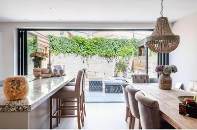 a kitchen with a table and chairs and a large window at Beachhouse36 in Zandvoort