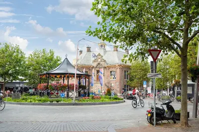 a moped parked in front of a building with a gazebo at Therese with free parking in Zandvoort