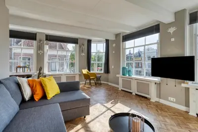 a living room with a couch and a flat screen tv at Authentic apartment in Alkmaar in Alkmaar
