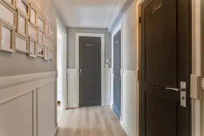 a hallway with a black door in a room at Authentic apartment in Alkmaar in Alkmaar