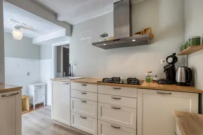 a kitchen with white cabinets and a stove at Authentic apartment in Alkmaar in Alkmaar