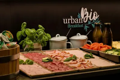 a table topped with different types of meat and vegetables at Motel One Amsterdam in Amsterdam
