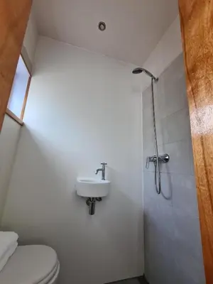a bathroom with a toilet and a sink and a shower at Tiny Garden Room - in city center in Alkmaar