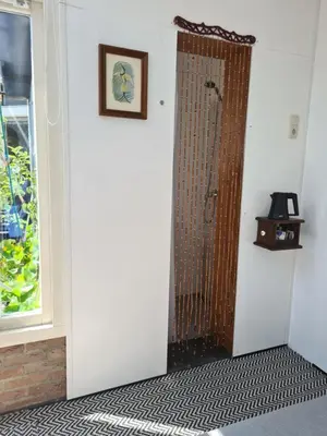 a door in a room with a window at Tiny Garden Room - in city center in Alkmaar