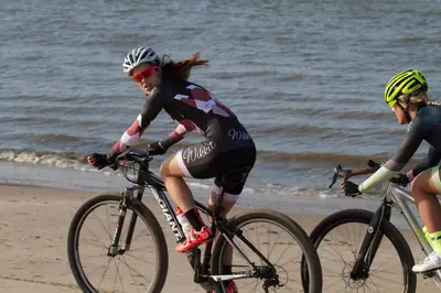 three people riding bikes on the beach at Duinberk B&B hotel en Brasserie in Schoorl