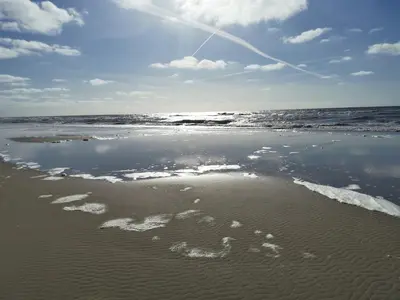 a view of the beach with the tide coming in at Duinberk B&B hotel en Brasserie in Schoorl