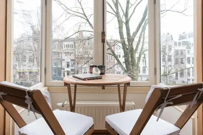 a table and two chairs in front of a window at A B&B Amsterdam in Amsterdam