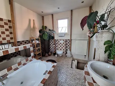 a bathroom with a large tub and a sink at A B&B Amsterdam in Amsterdam