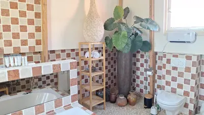 a bathroom with a tub and a toilet and a sink at A B&B Amsterdam in Amsterdam