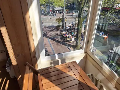 a wooden bench sitting in front of a window at A B&B Amsterdam in Amsterdam