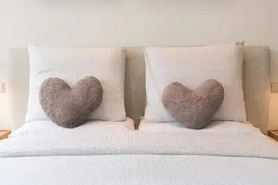 two heart pillows sitting on top of a bed at A B&B Amsterdam in Amsterdam