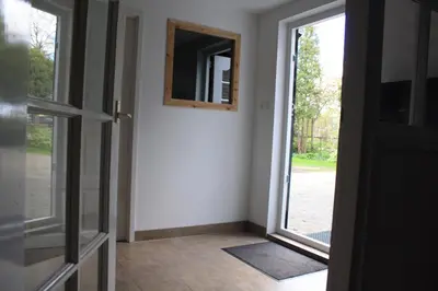 an empty room with a door and a mirror at Bed & Breakfast De Stolp in Zuidoostbeemster