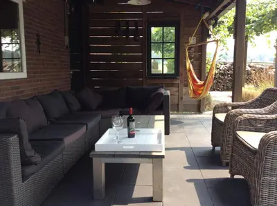 a couch and a coffee table on a patio at Bed & Breakfast De Stolp in Zuidoostbeemster