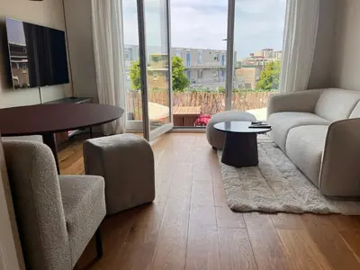 a living room with a couch and a table at Appartement Huis ter Duinstraat in Noordwijk aan Zee