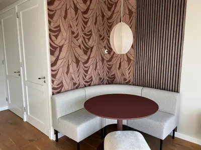 a living room with a couch and a table at Appartement Huis ter Duinstraat in Noordwijk aan Zee